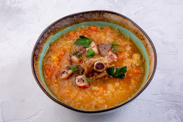 Lamb shurpa soup. Lamb, potatoes, carrots, peppers, onions on the light background. Eastern cuisine. The work of a professional chef. Dish from a restaurant or cafe menu. Top view
