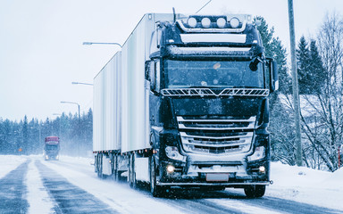 Truck in the Snowy winter Road in Finland in Lapland reflex
