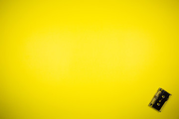 Retro audio cassette on a yellow background