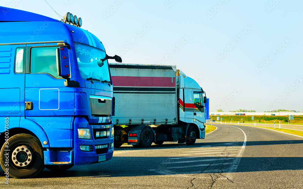 Wall mural trucks in asphalt road of poland reflex