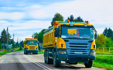 Fototapeta na wymiar Trucks at asphalt road in Poland reflex