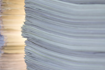 documents in large quantities are on the table. archived paper reports.