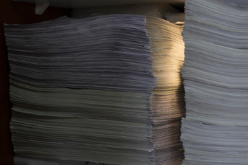 documents in large quantities are on the table. archived paper reports.