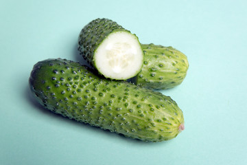 Short cucumbers on a green background
