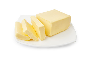 Sliced butter of piece butter on white plate isolated on white background.
