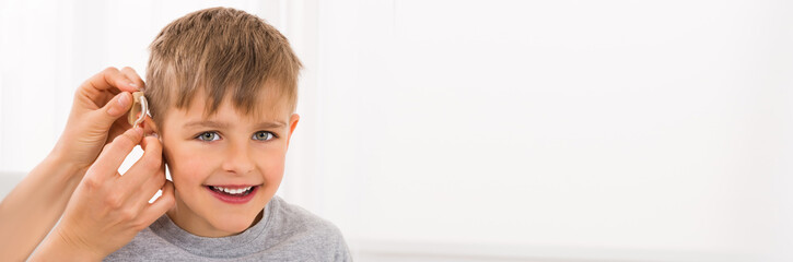 Close-up Of A Smiling Boy With Hearing Aid