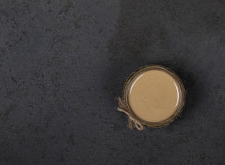 Paste of sunflower seeds in a jar in rustic style on a light background top view