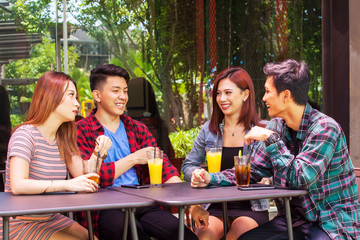 Group of friends talking together in restaurant