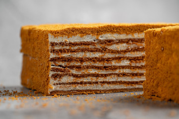 layer cake on a black background, homemade honey cake , dark background