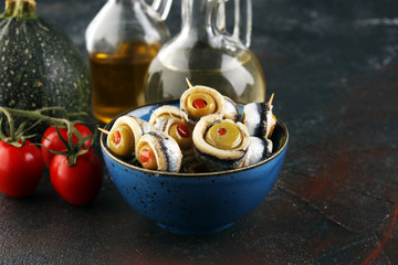 Cuisine  Marinated anchovies with vinegar olive oil parsley and green olives, fish appetizers antipasti