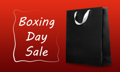 Boxing day sale. Shopping bag on red background