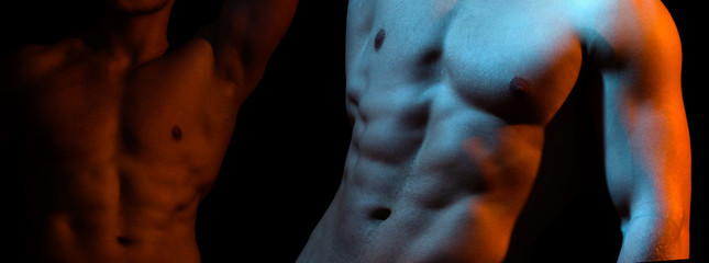 Two naked athlete with strong body. Shirtless hunks at black background. Close up of an athletic...