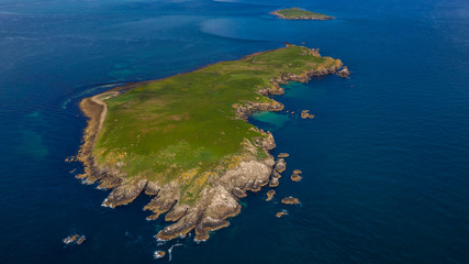 Aerial GREAT SALTEE ISLAND, IRELAND, Birds in Saltee islands and a boat near the isla