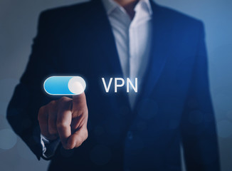 Private network security concept.
Businessman hand tapping button  on VPN. 