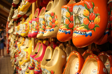 Colorful Dutch clogs in the foreground, hanging and tidy on the wall
