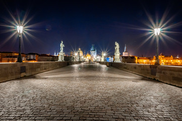 Obraz premium Empty Charles Bridge in Prague at night. Empty Prague during pandemic covid-19. No people.