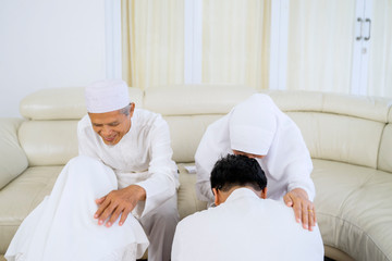 Muslim family celebrating eid mubarak at home