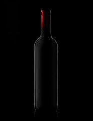 Silhouette of a wine bottle without label on a black background, mock-up