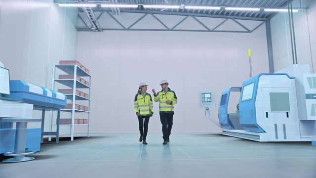 Two Engineers Walk Through Factory Workshop with Augmented Reality Creating 3D Models CNC Machinery Production Line. Industry 4.0 Graphics Visualization in Factory. VFX Special Visual Effects