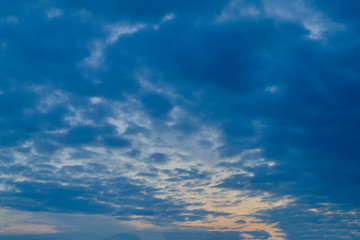 The sky at sunset. Cumulus clouds lit by the rays of the setting sun.