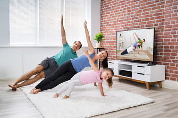 Family Doing Home Online Fitness Plank Exercise