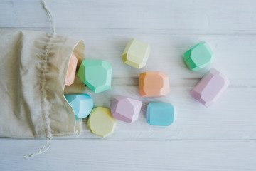 Linen bag with children's wooden cubes of unusual shape.