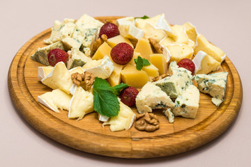 Dairy products, assorted different types of cheeses on a dish. Horizontal frame