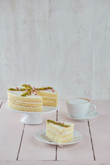 
Cake on a white plate with a fork and coffee