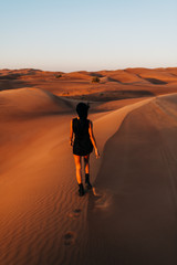 Fototapeta na wymiar Girl walking in the desert 