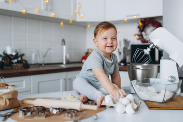 happy family funny boy preparing the dough, bake cookies in the kitchen