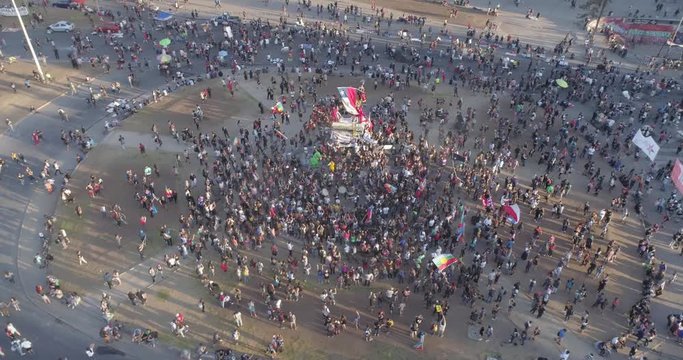 People crowds protesting at Santiago, Chile streets in Plaza de Italia during Chile protests. Aerial view. 4K.