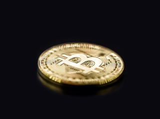 digital currency, Bitcoin, decentralized cryptocurrency, electronic money for point-to-point transactions. Coin isolated on black background with spot focus