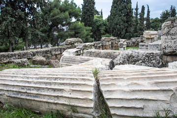 One broken columns with a huge crack laying on the ground in Athens. Ancient ruins