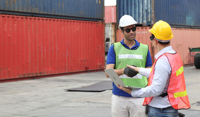 Engineering group working and they are loading container for support logistics and import export business