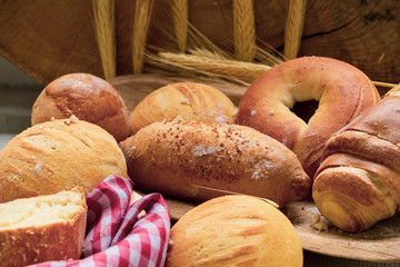 Baked breads on wooden table background.