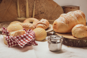 Baked breads on wooden table background.