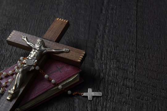 Christian cross on wood bible and rosary beads over wooden vintage background - Powered by Adobe