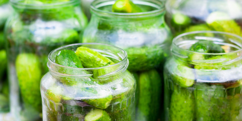 the process of canning pickled gherkins for the winter, pickles cucumbers in glass jars close-up