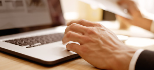 Closeup of male hand with laptop