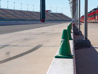 Green Safety Cones on Pit Area At Race Track - obrazy, fototapety, plakaty