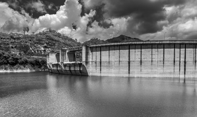 dramatic black and white image of a dam in the mountains of the caribbean in the dominican republic.