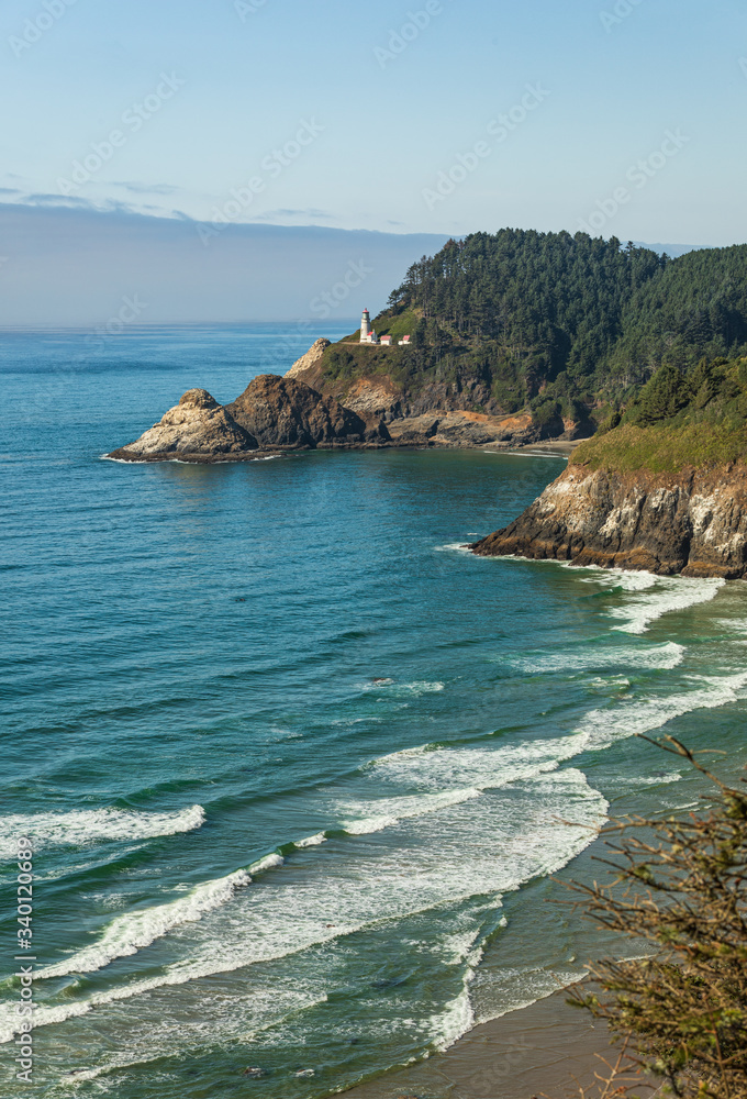Wall mural vertical image - beach and cliffs leading to heceta head lighthouse as seen from overlook with fog b