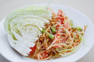 spicy papaya salad on wood floor - Thailand healthy food