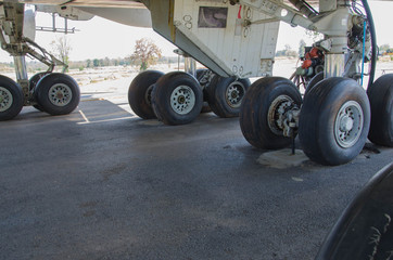 Big black tires of passenger airplane on the floor