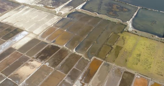 Aerial view showing a patchwork of salt reclamation ponds in Chile. Algae turn the ponds red-purple as concentration increases. 4K.