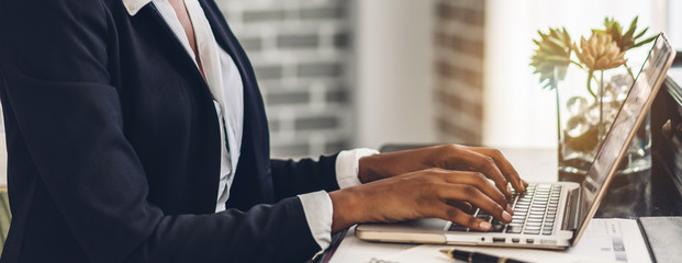 African american black woman relaxing using technology of laptop computer while sitting on...