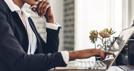 African american black woman relaxing using technology of laptop computer while sitting on table.Young creative african girl working at home.work from home concept