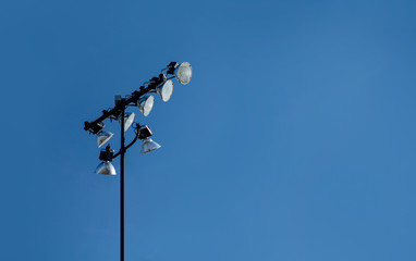 tall pole high powered event lights during blue day clear sky