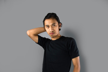 Young asian men with smart thinking gesture, using t-shirt ,isolated background. 