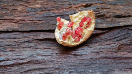 Orange-Red Pomegranate fruit still raw, on old wooden background.